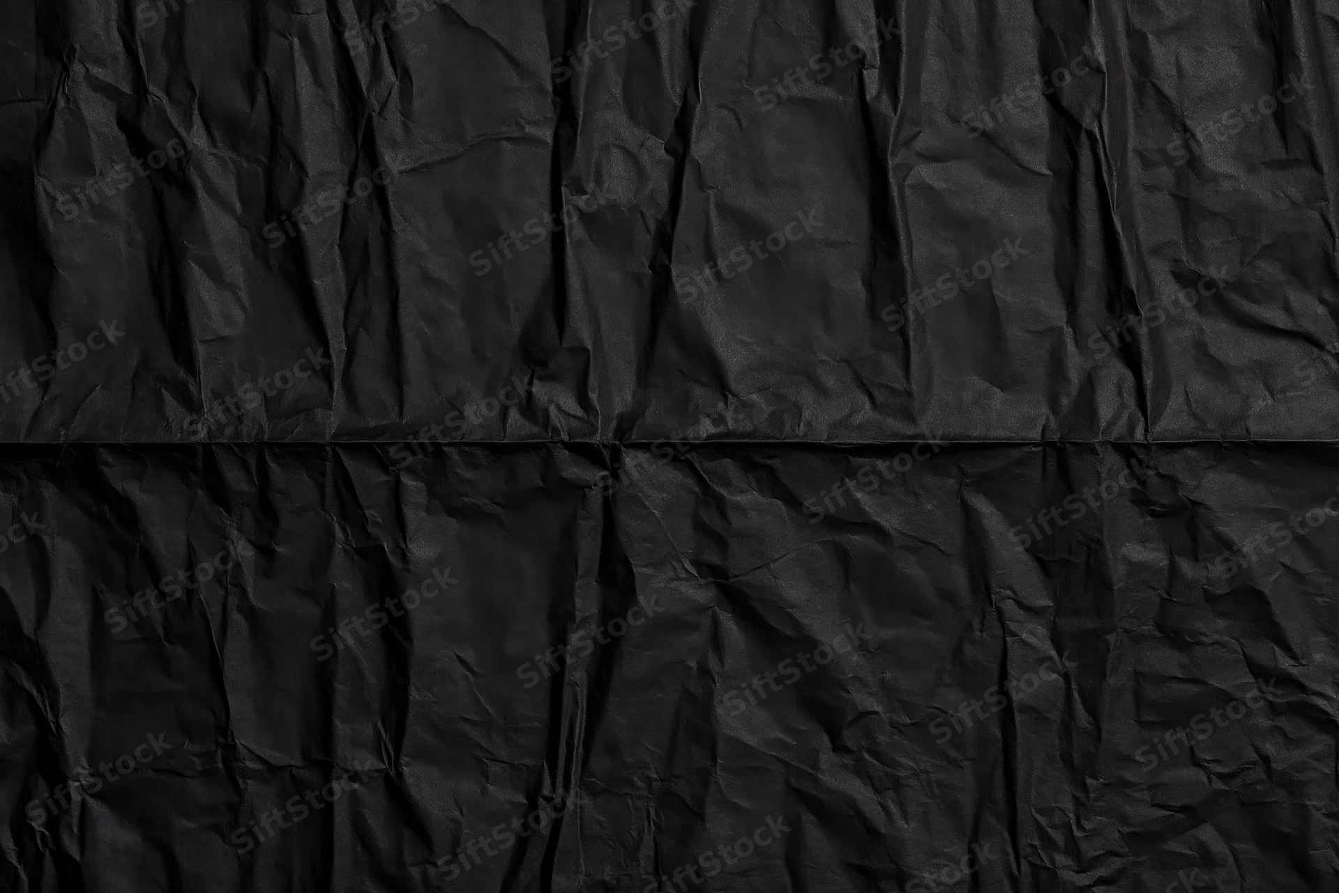 Crumpled black paper texture in flat lay arrangement