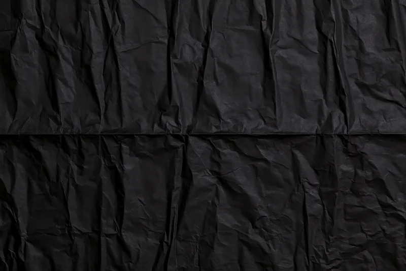 Crumpled black paper texture in flat lay arrangement