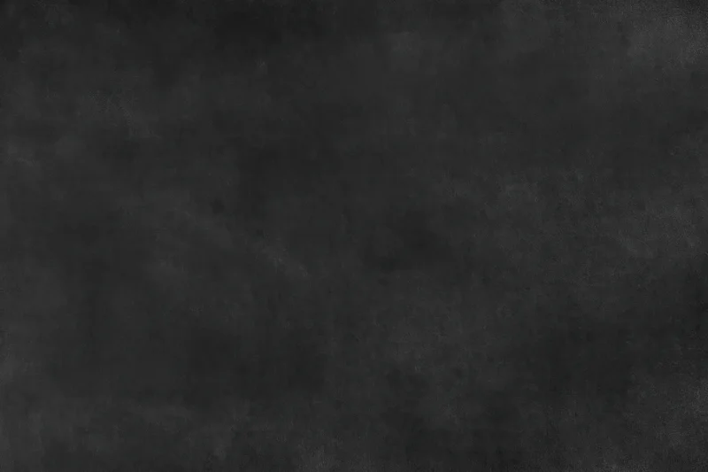 Close-up of a dark black textured surface with subtle grain and matte finish