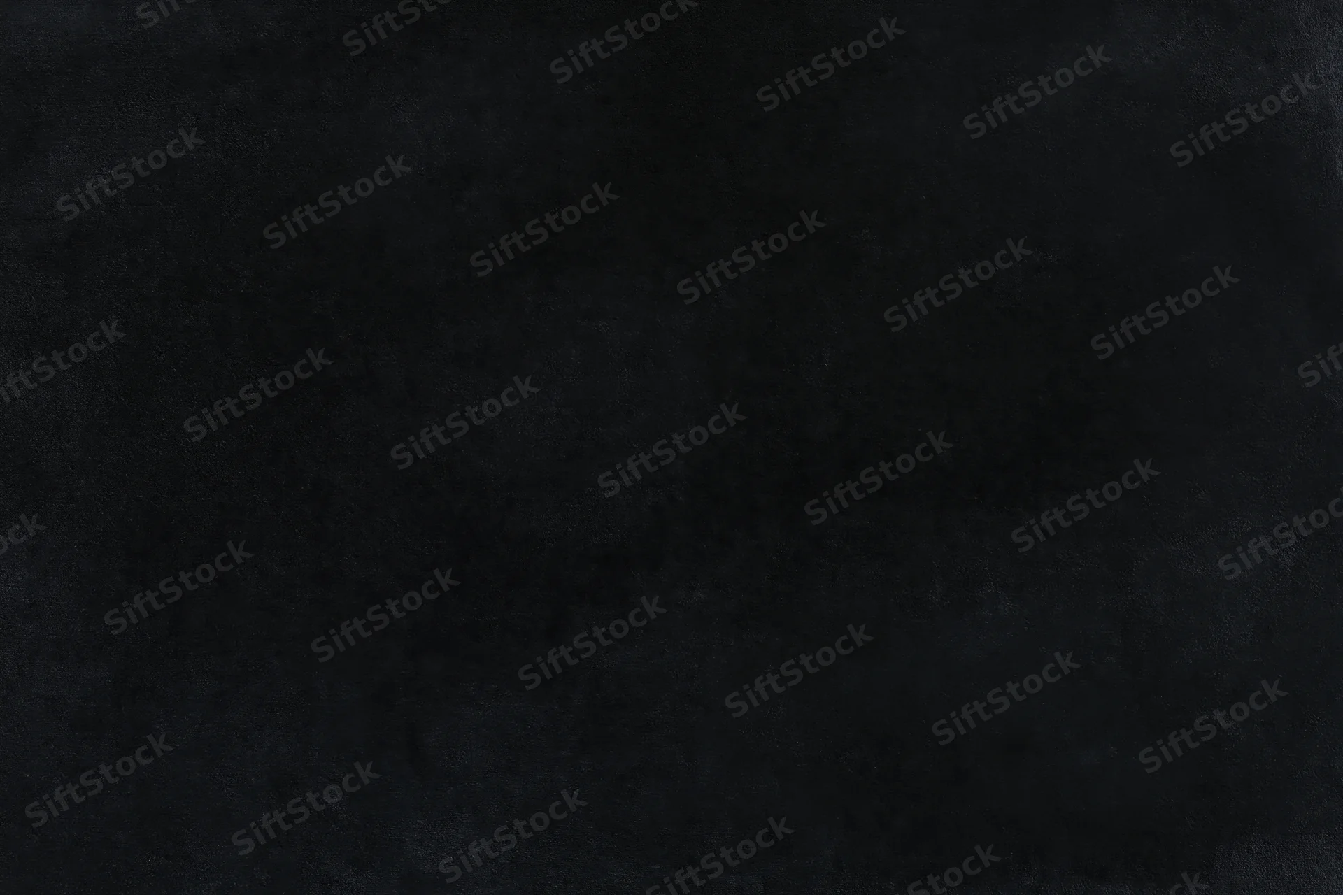 Close-up of a dark black velvet surface with soft texture and subtle grain