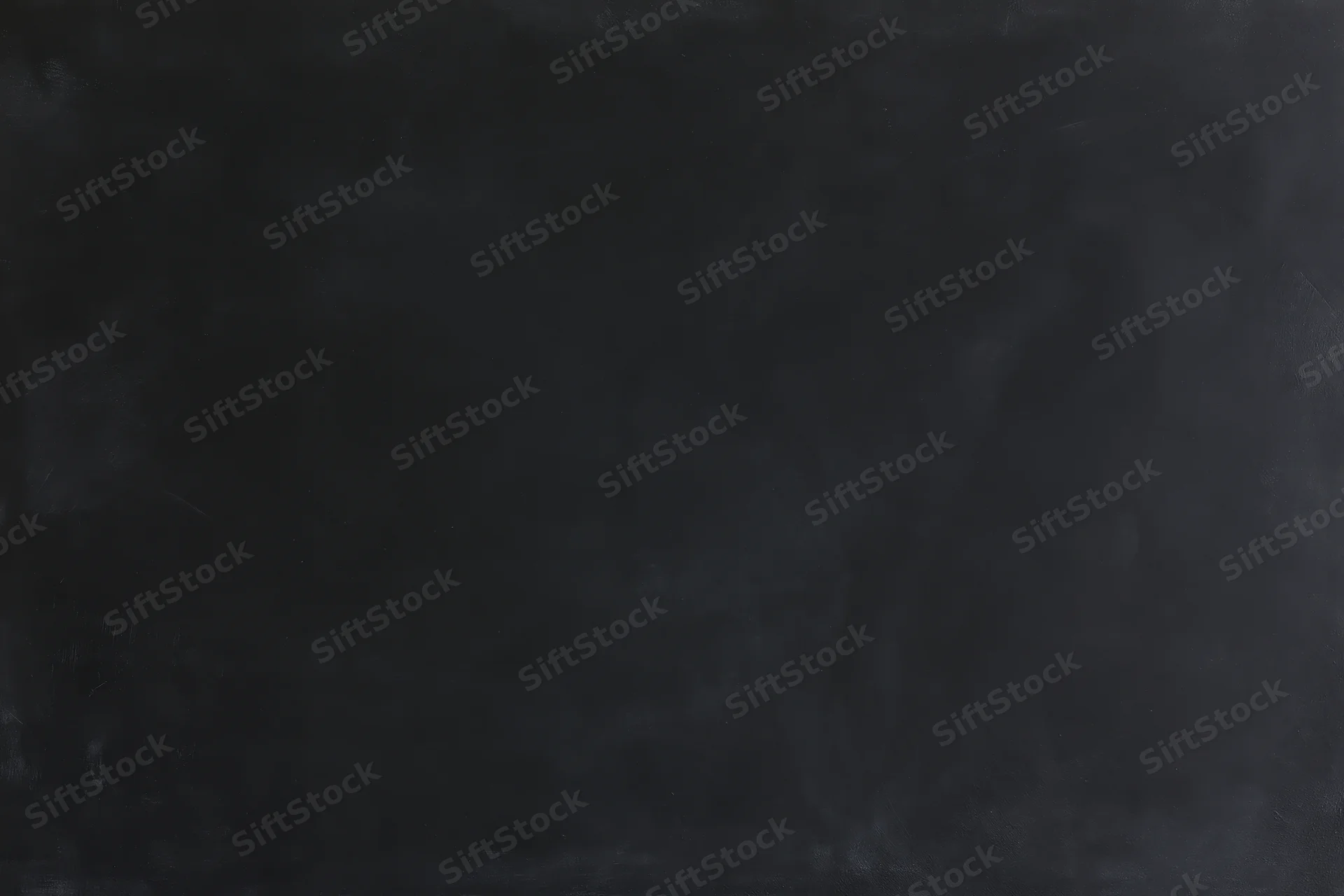 Close-up of a dark empty chalkboard surface in a classroom setting