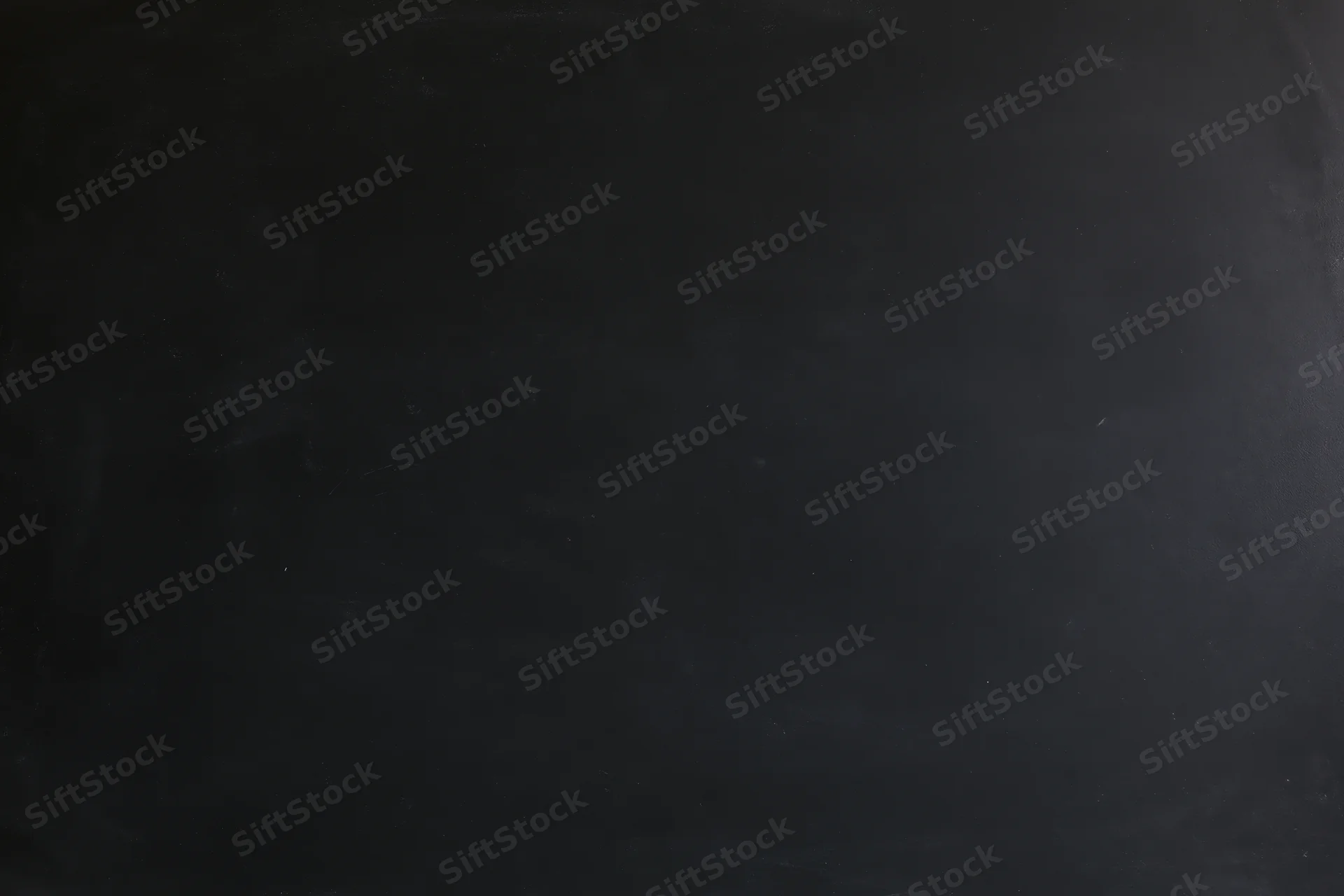 Close-up flat lay of a dark blackboard surface