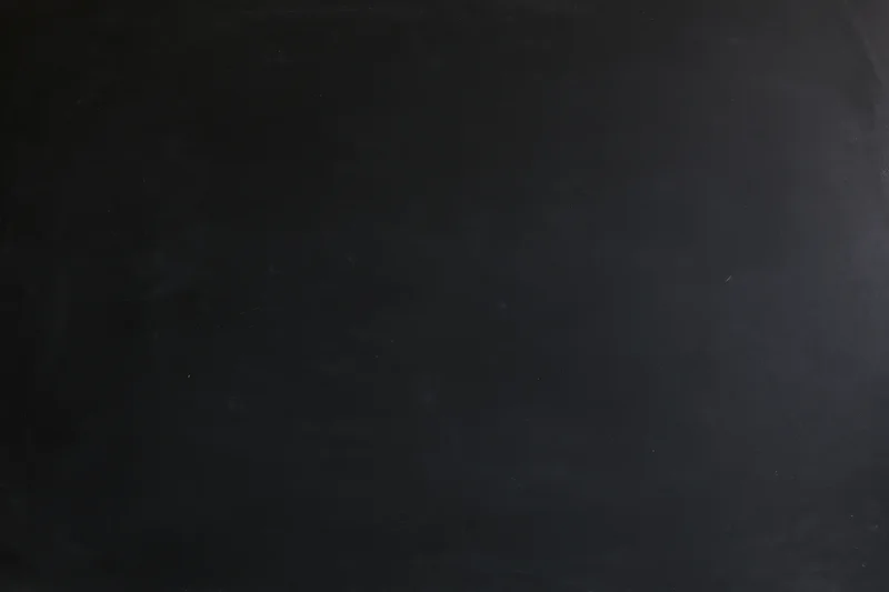 Close-up flat lay of a dark blackboard surface