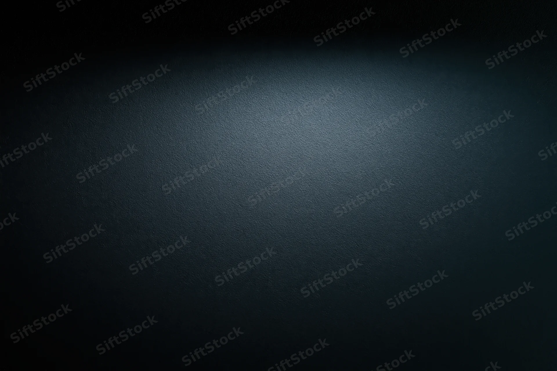 Dark matte surface with spotlight gradient and copyspace