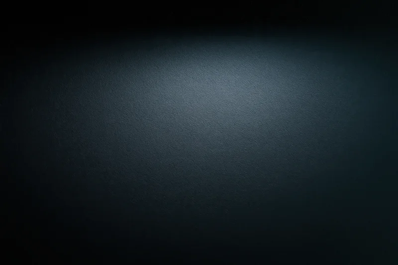 Dark matte surface with spotlight gradient and copyspace