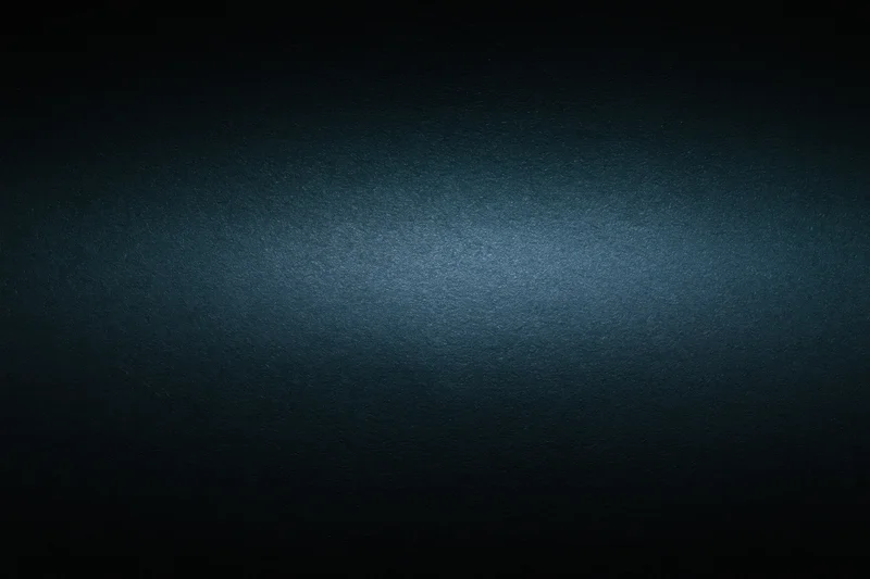 Dark charcoal matte surface with subtle gradient and soft lighting, close-up flat lay view