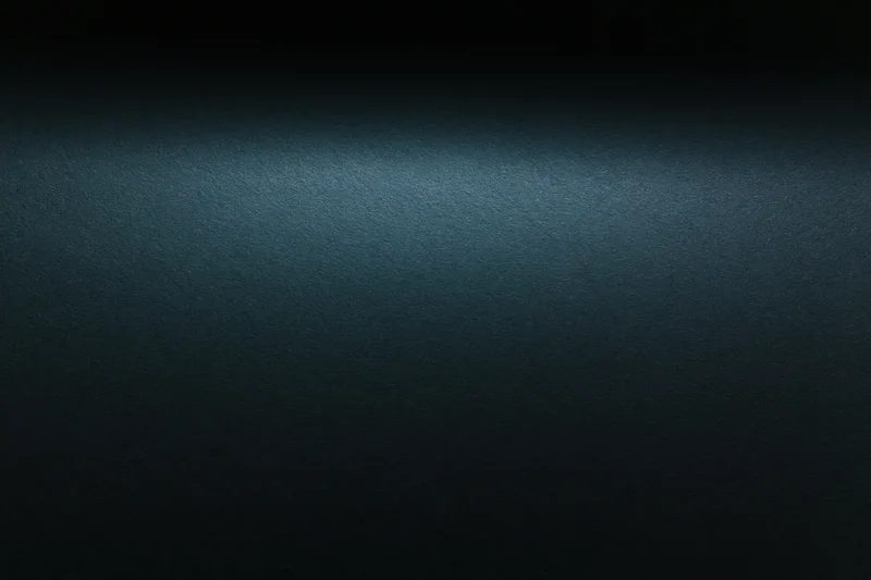 Dark matte surface with subtle gradient and texture, flat lay view