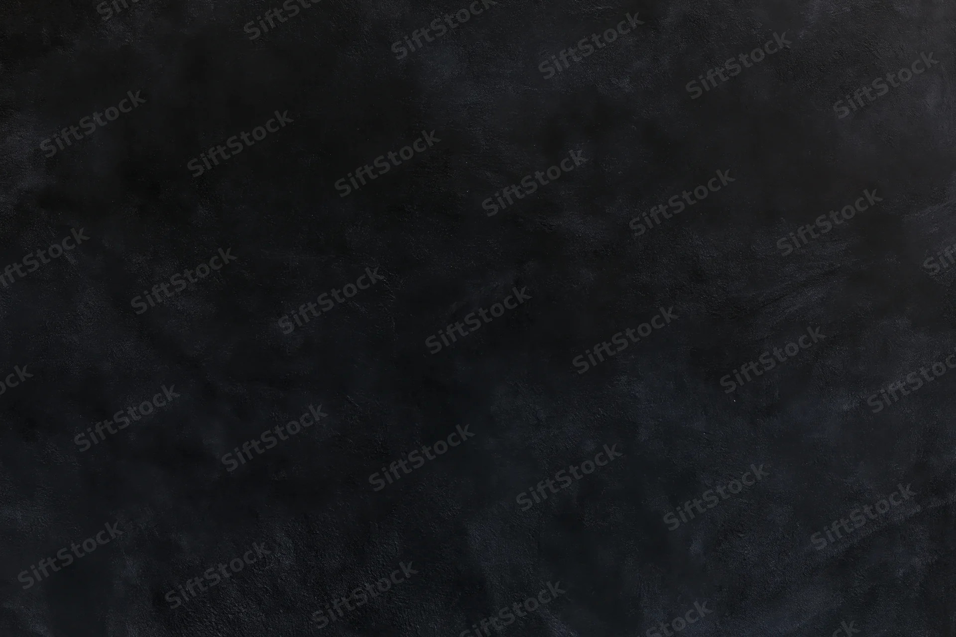 Close-up of dark textured concrete wall surface