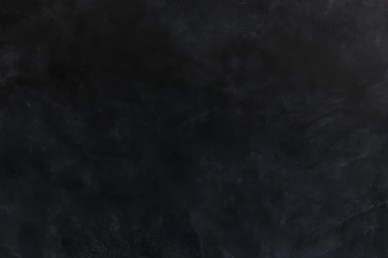 Close-up of dark textured concrete wall surface