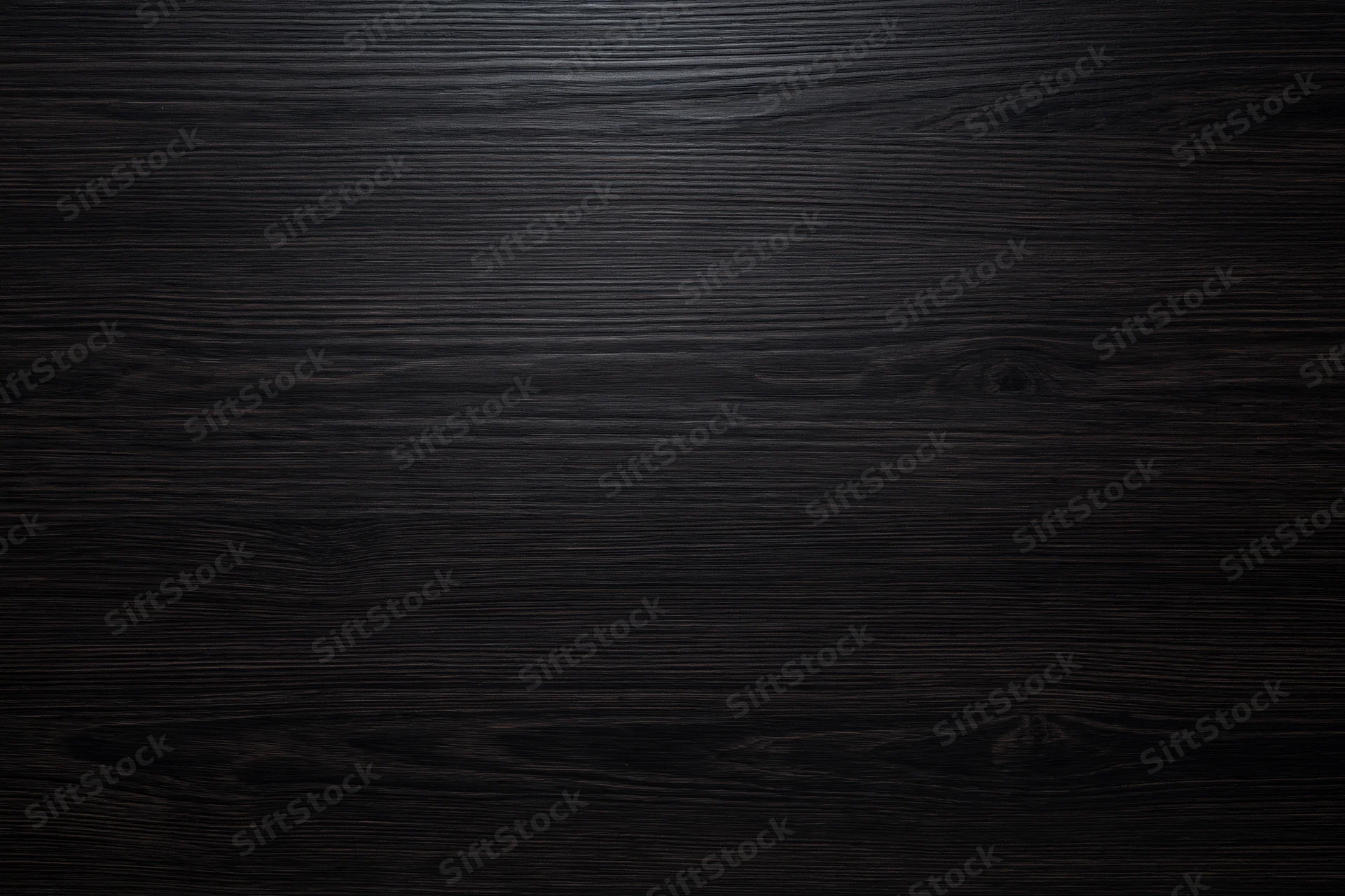 Close-up of dark ebony wood surface with visible grain and knots filling the frame