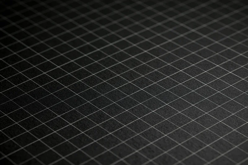 Close-up flat lay of dark matte black graph paper surface with grid pattern
