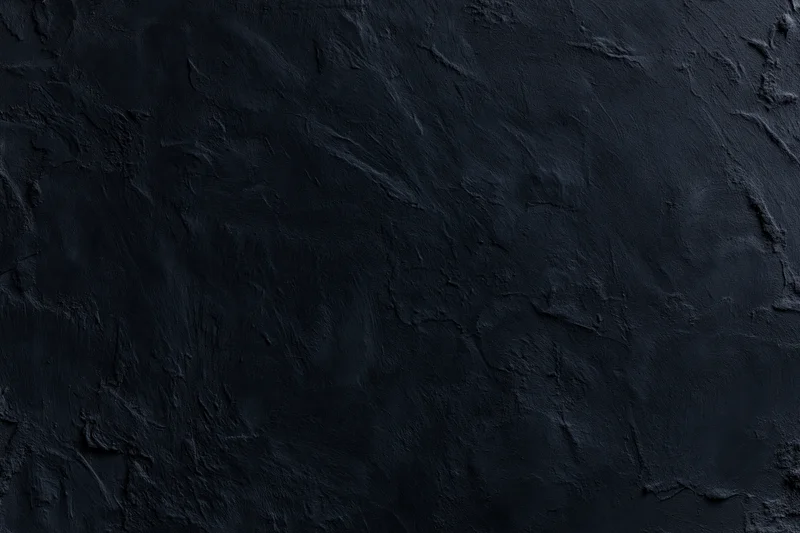 Close-up of dark textured wall surface with rough uneven finish