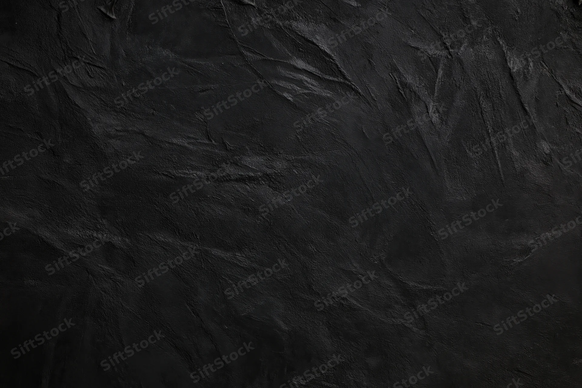 Close-up of dark textured wall surface with rough uneven finish