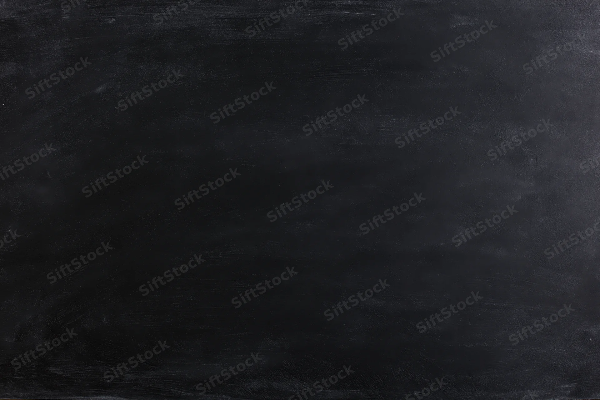 Close-up flat lay of a matte black chalkboard surface filling the frame with subtle texture and even lighting