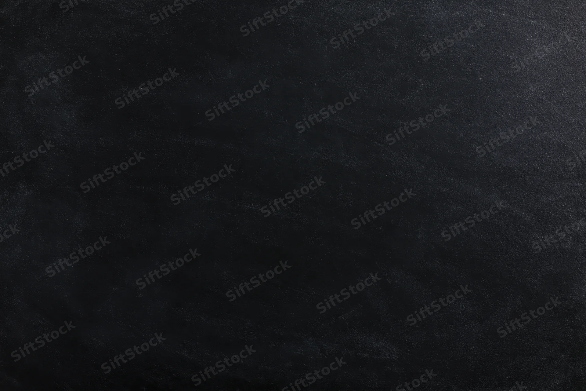 Close-up flat lay of a matte black chalkboard surface filling the frame