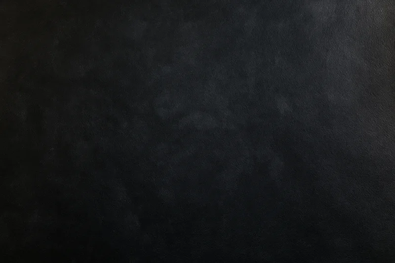 Close-up of a matte black textured surface filling the frame
