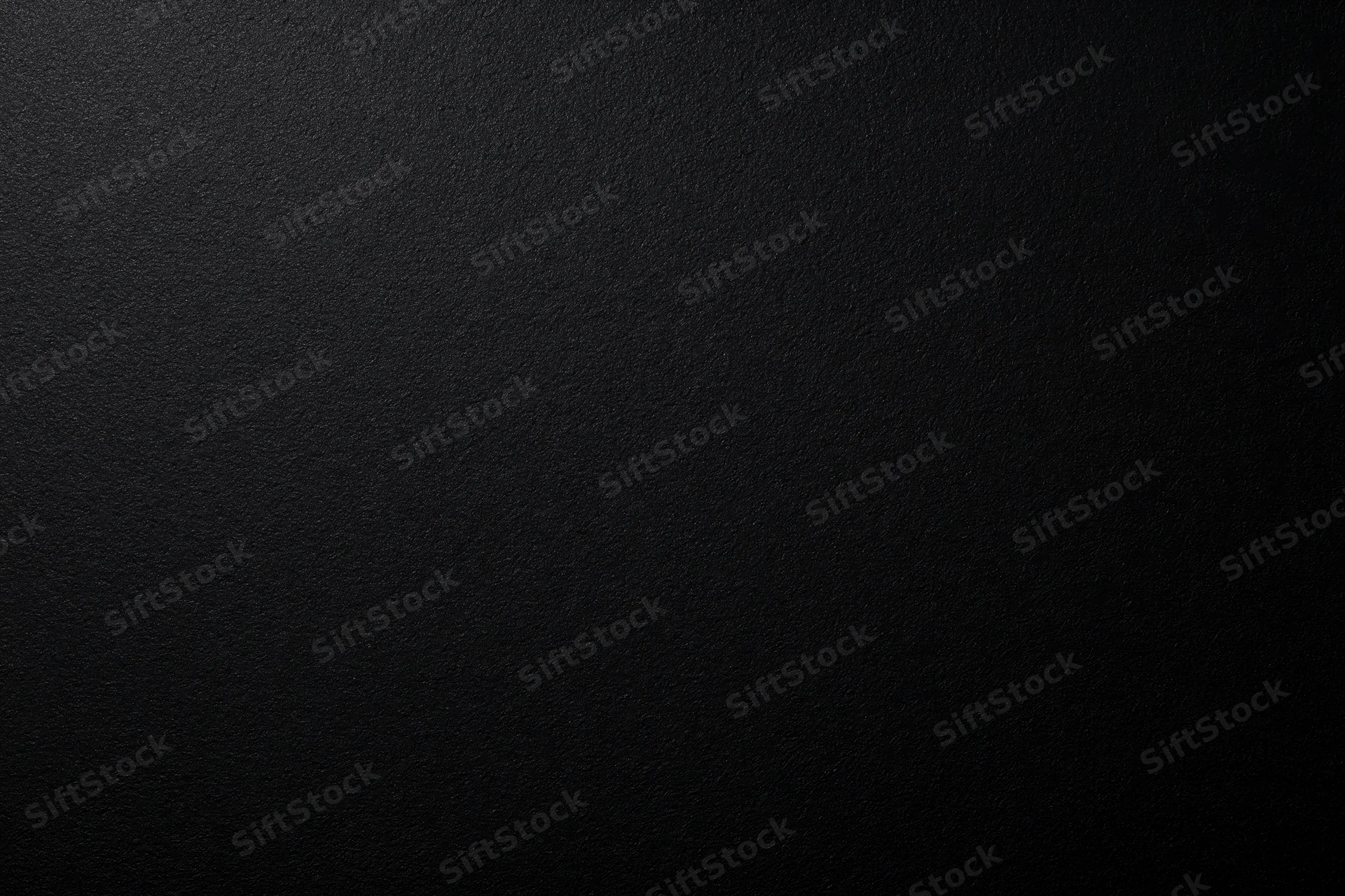 Close-up of a matte black textured surface filling the frame