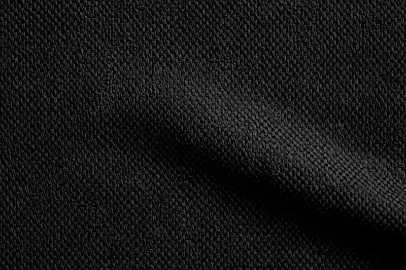 Close-up of black woven fabric with visible texture and folds filling the frame