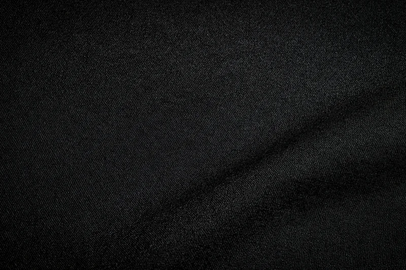 Close-up of black woven fabric texture filling the frame