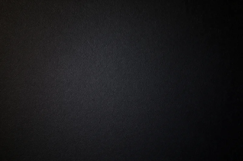 Close-up of matte black textured paper surface in flat lay arrangement