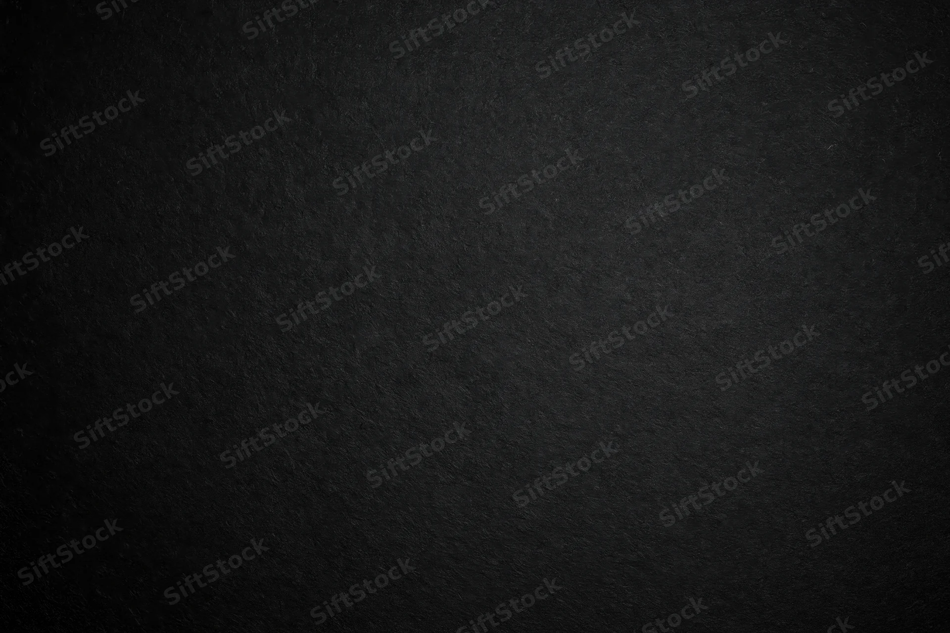 Close-up of matte black textured paper surface