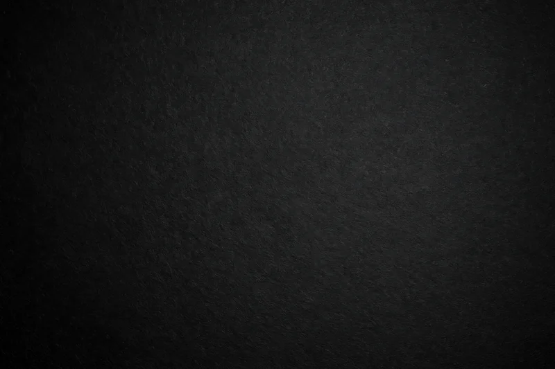 Close-up of matte black textured paper surface