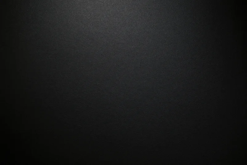 Close-up of matte black textured paper surface in flat lay arrangement
