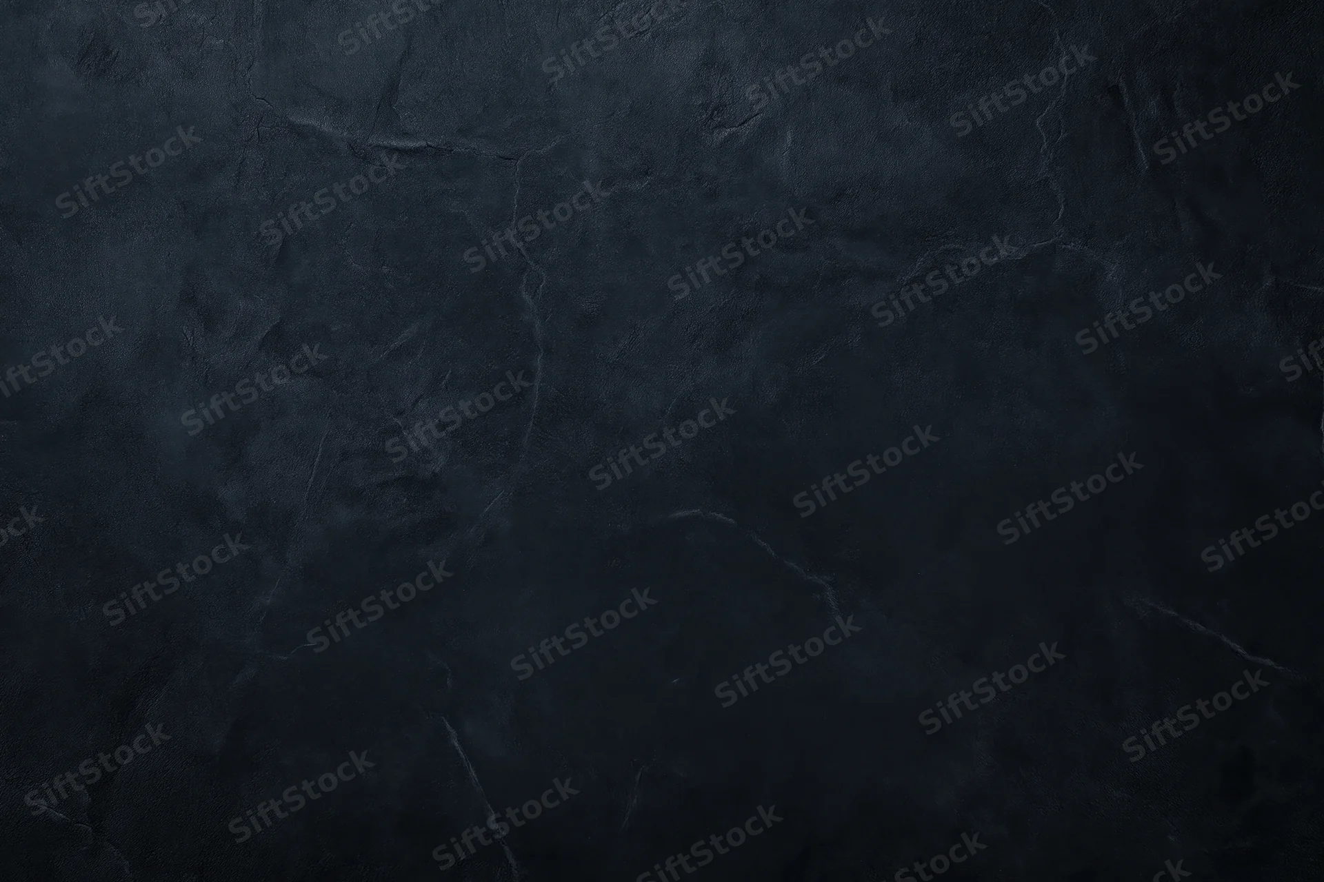 Close-up of dark textured concrete wall surface