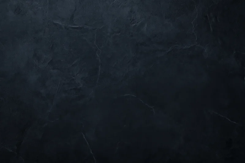 Close-up of dark textured concrete wall surface