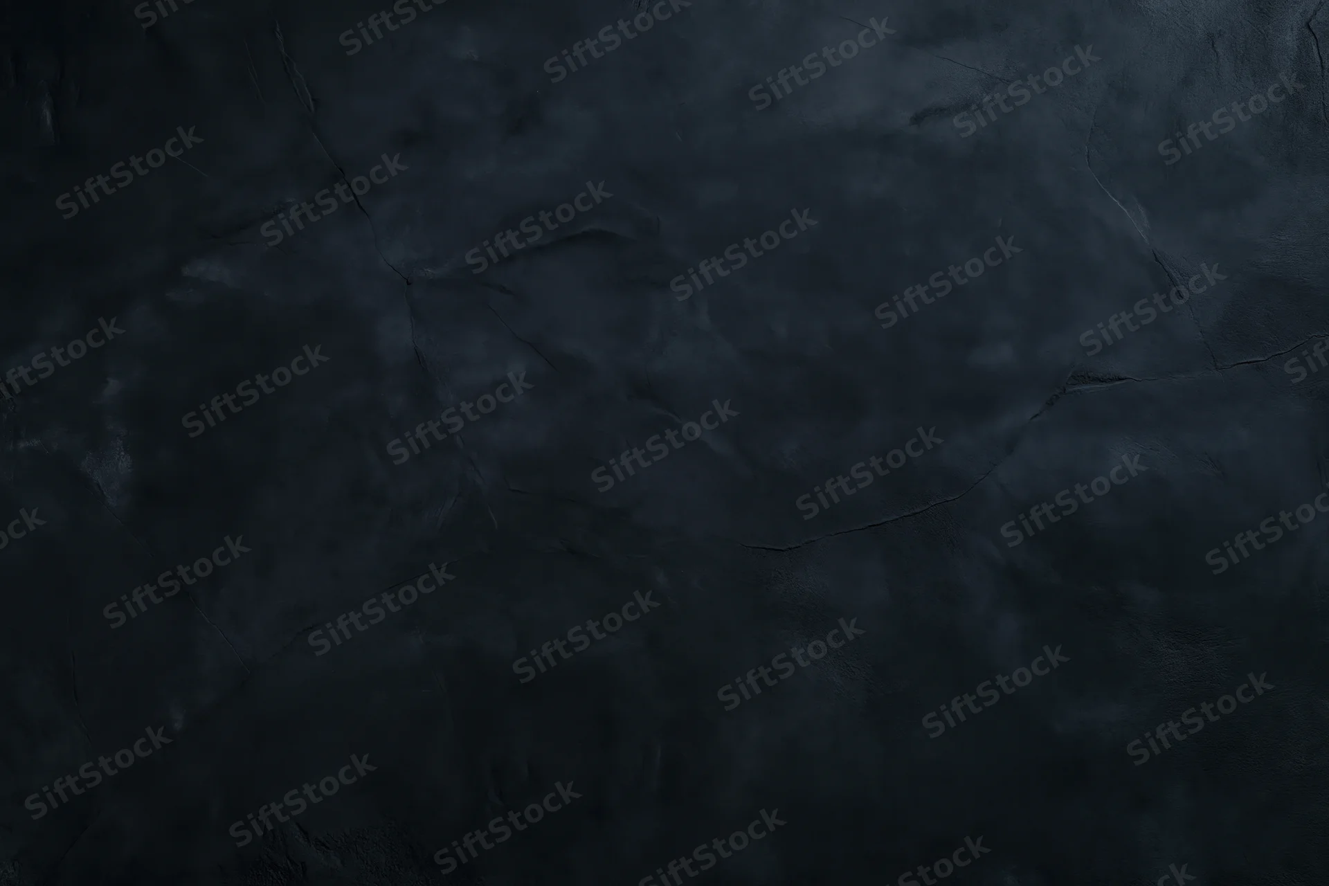 Close-up of dark cracked concrete wall surface