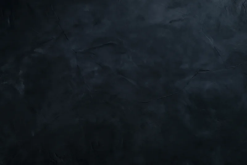 Close-up of dark cracked concrete wall surface