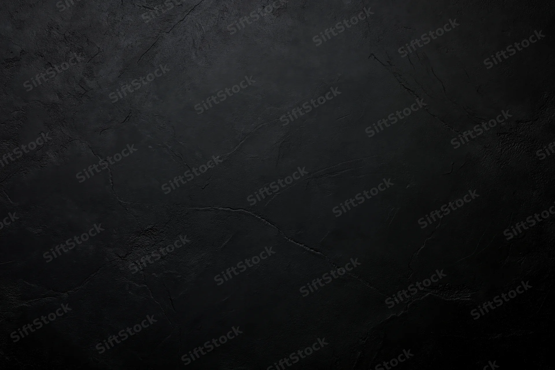 Close-up of dark cracked concrete wall surface