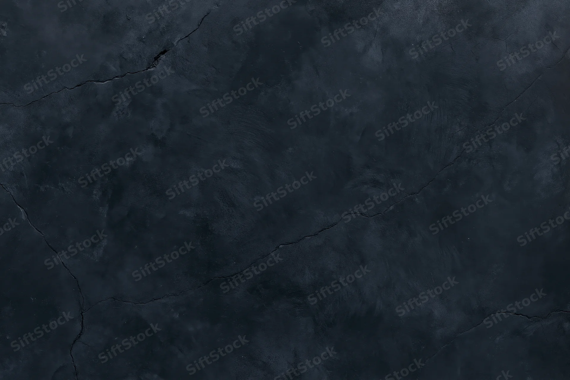 Close-up of cracked dark concrete wall surface