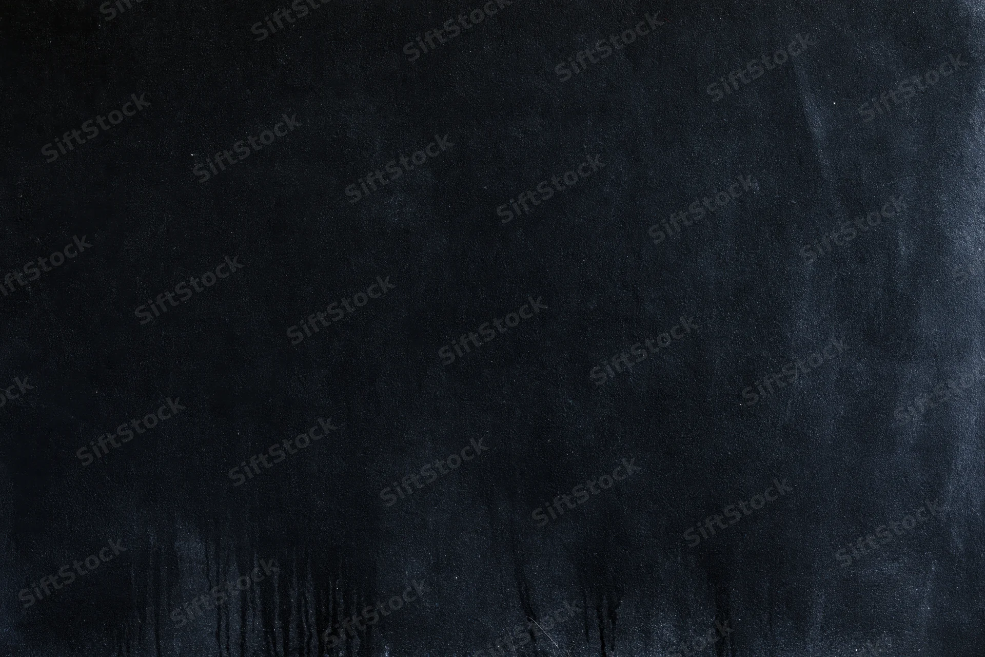 Dark matte concrete surface with smudged texture and streaks
