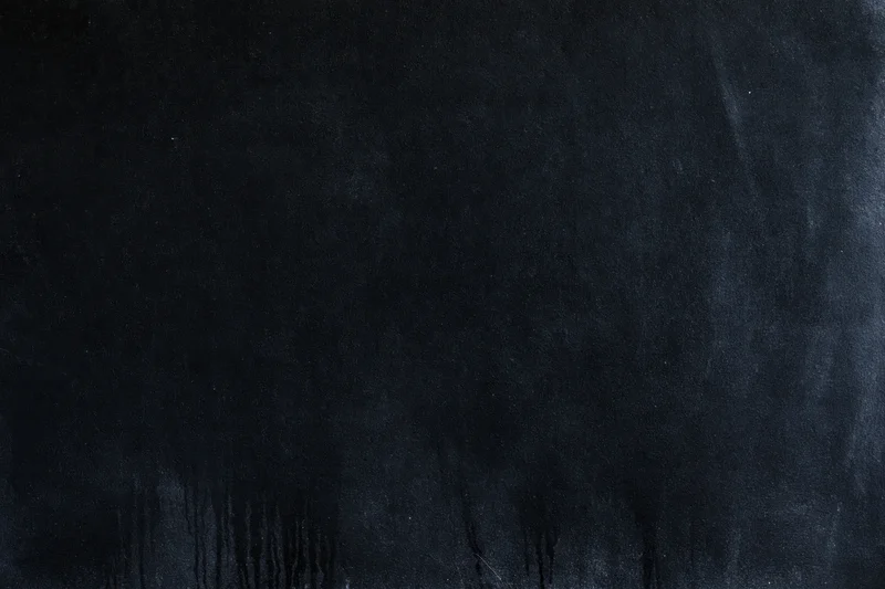 Dark matte concrete surface with smudged texture and streaks