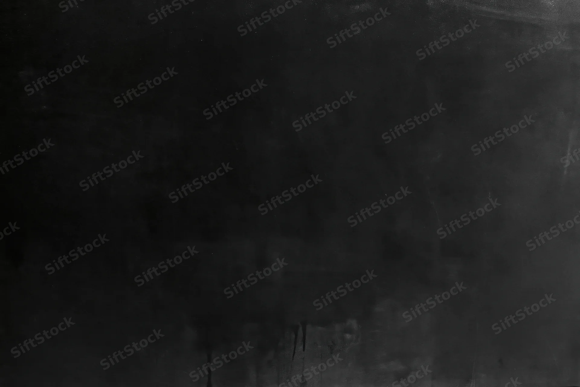 Close-up of dark matte concrete or metal surface with scratches and weathering