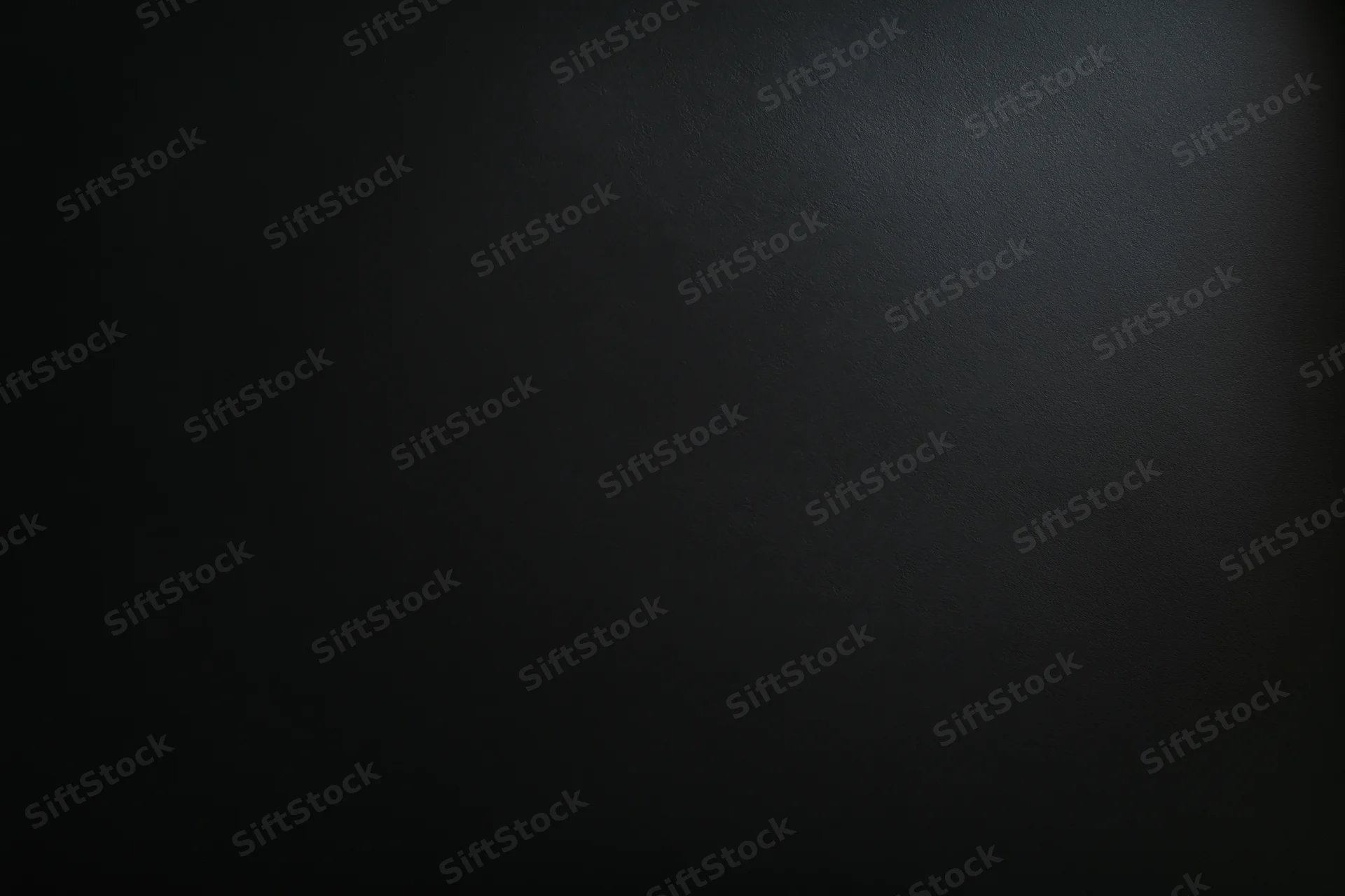 Dark charcoal matte surface filling the frame flat-on
