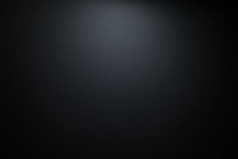 Dark charcoal matte surface with spotlight gradient filling the frame