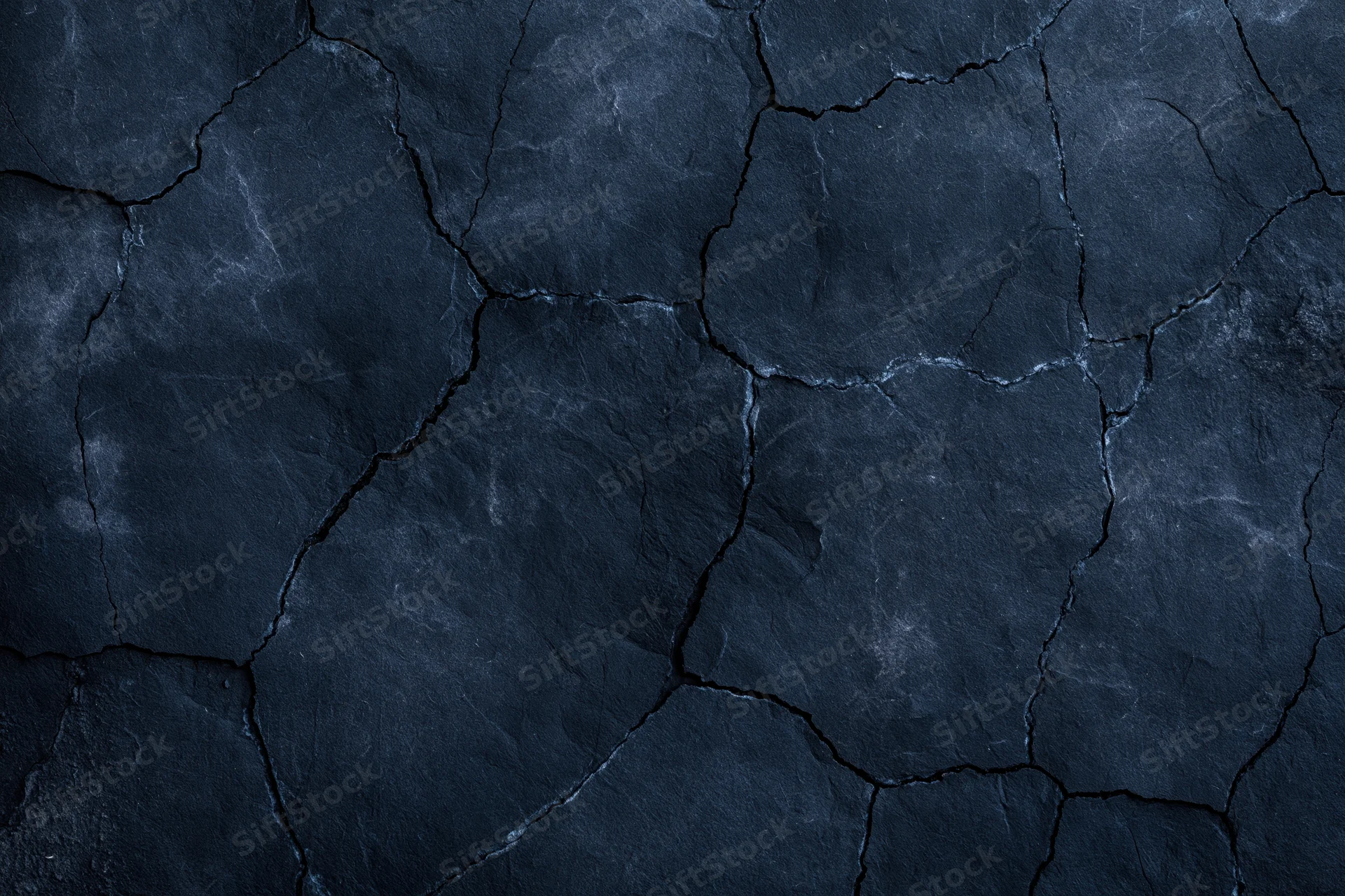 Dark cracked stone surface filling the frame as a textured background