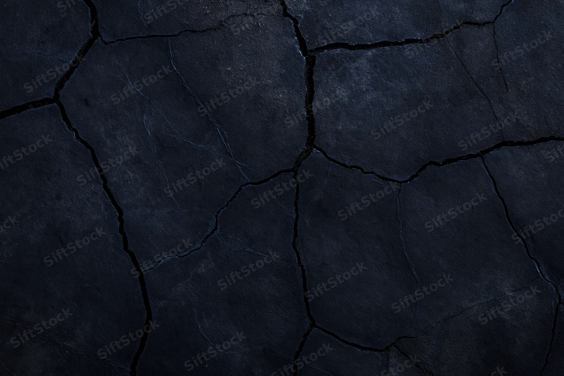 Dark cracked stone surface filling the frame as a textured background