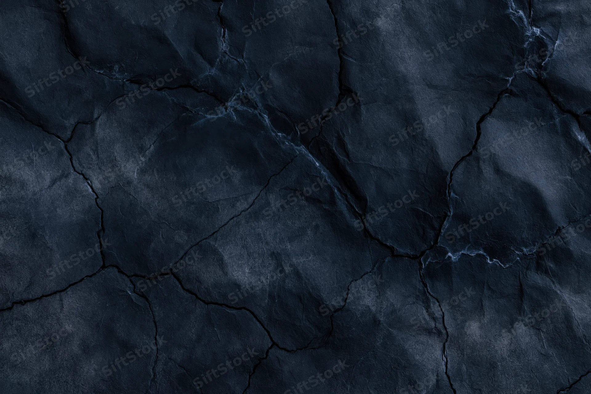 Dark cracked stone texture filling the frame as a seamless background