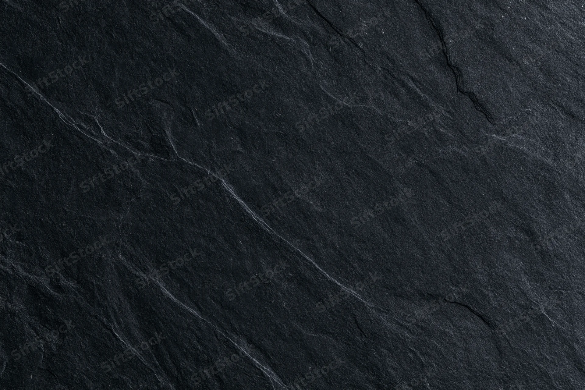 Dark slate stone surface texture filling the frame