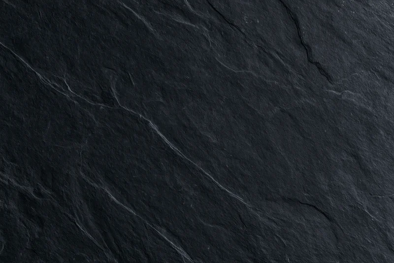 Dark slate stone surface texture filling the frame