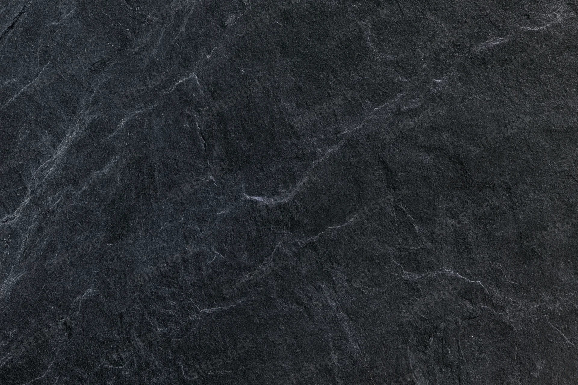 Dark slate stone surface texture filling the frame