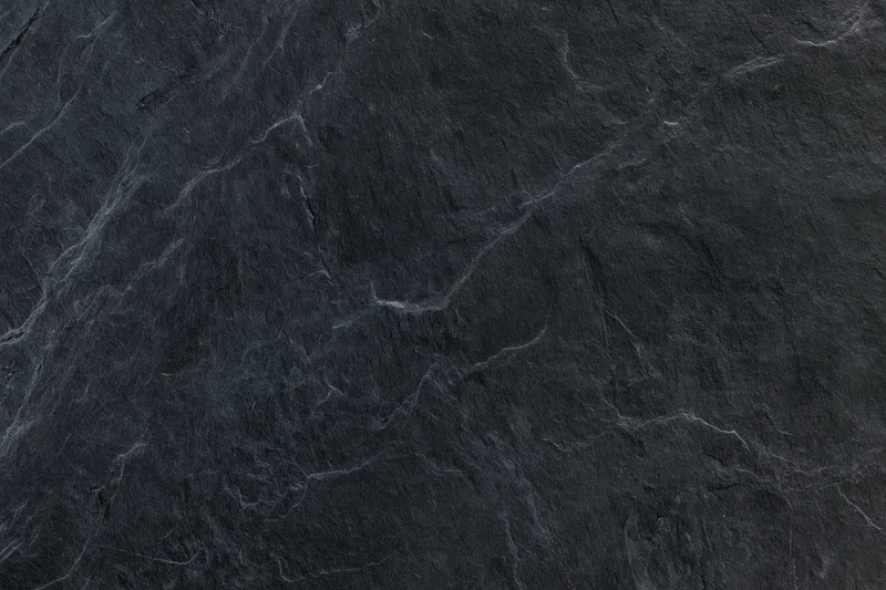 Dark slate stone surface texture filling the frame