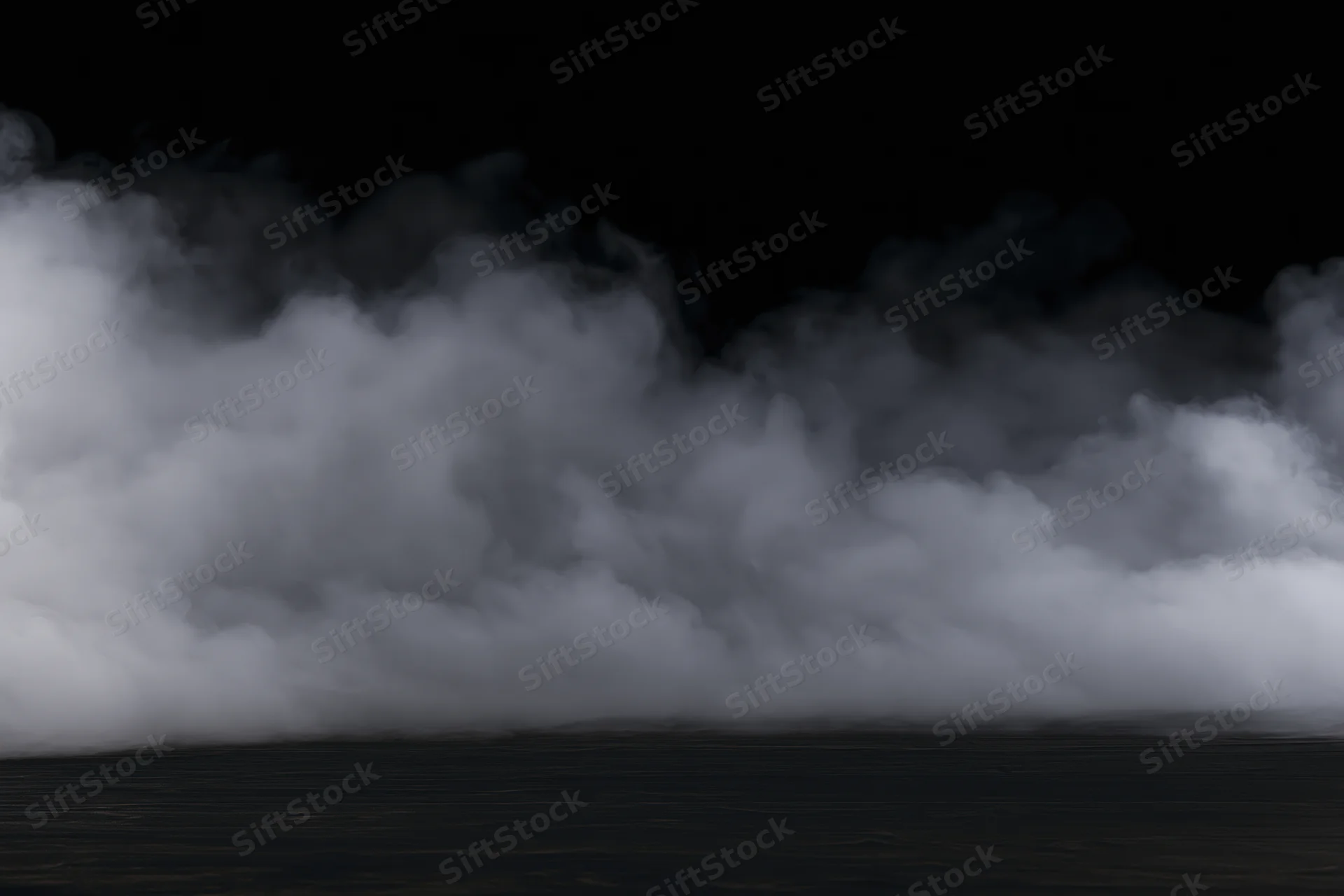 Dense white smoke drifting low across a dark flat surface
