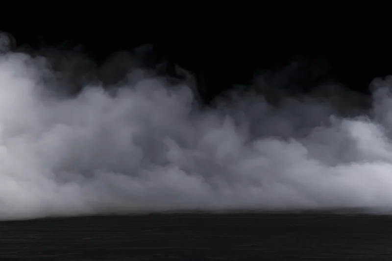 Dense white smoke drifting low across a dark flat surface