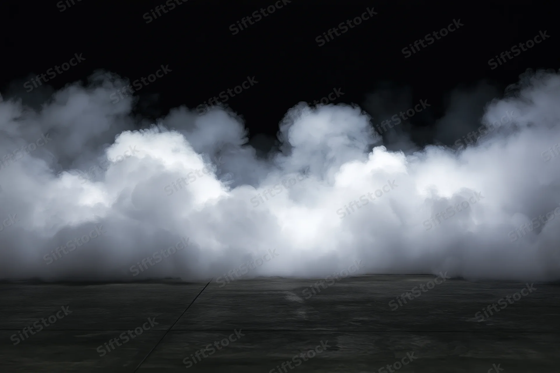 Dense white smoke rising from a dark concrete floor