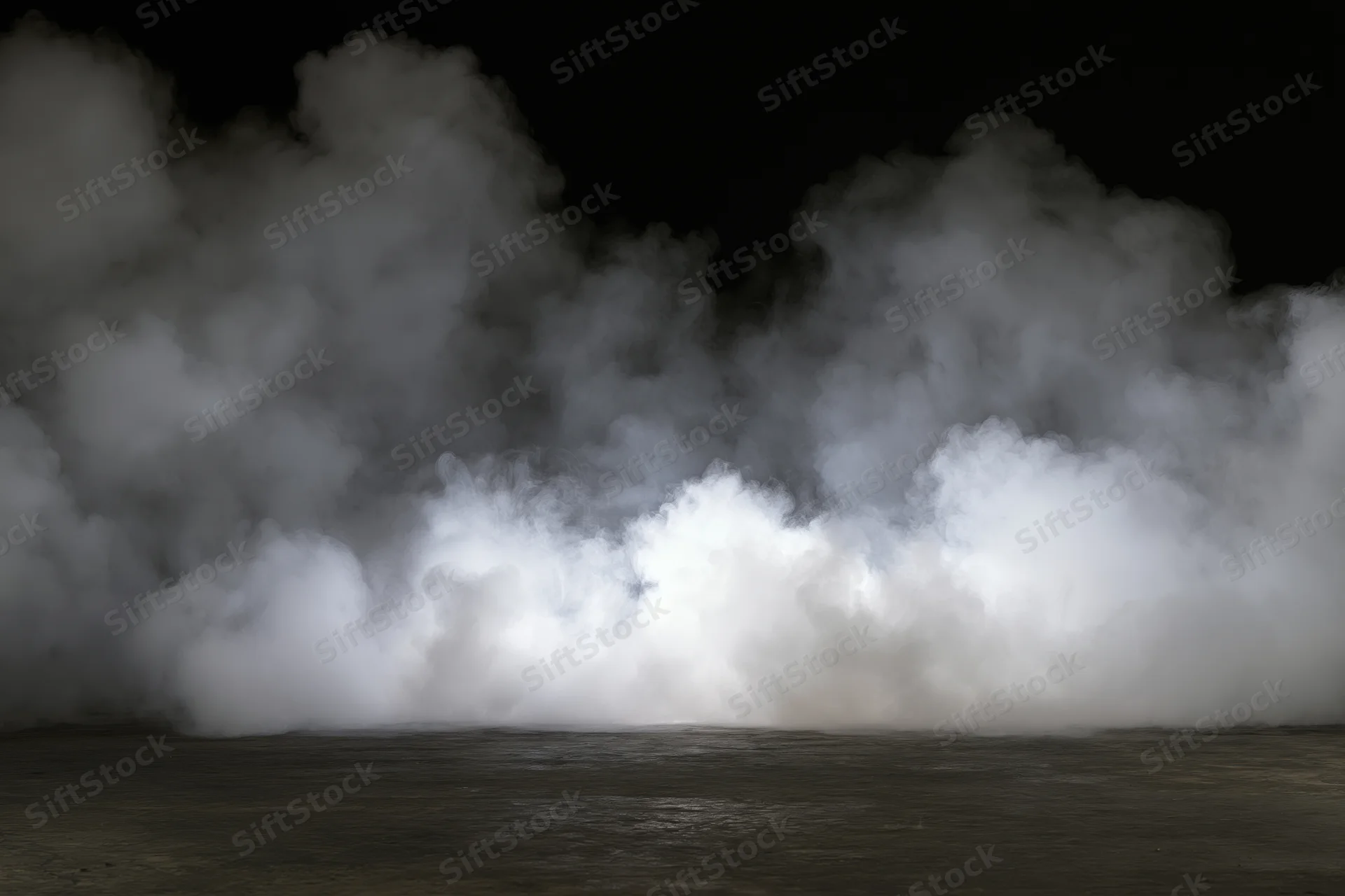 Dense white smoke rising from a dark concrete floor