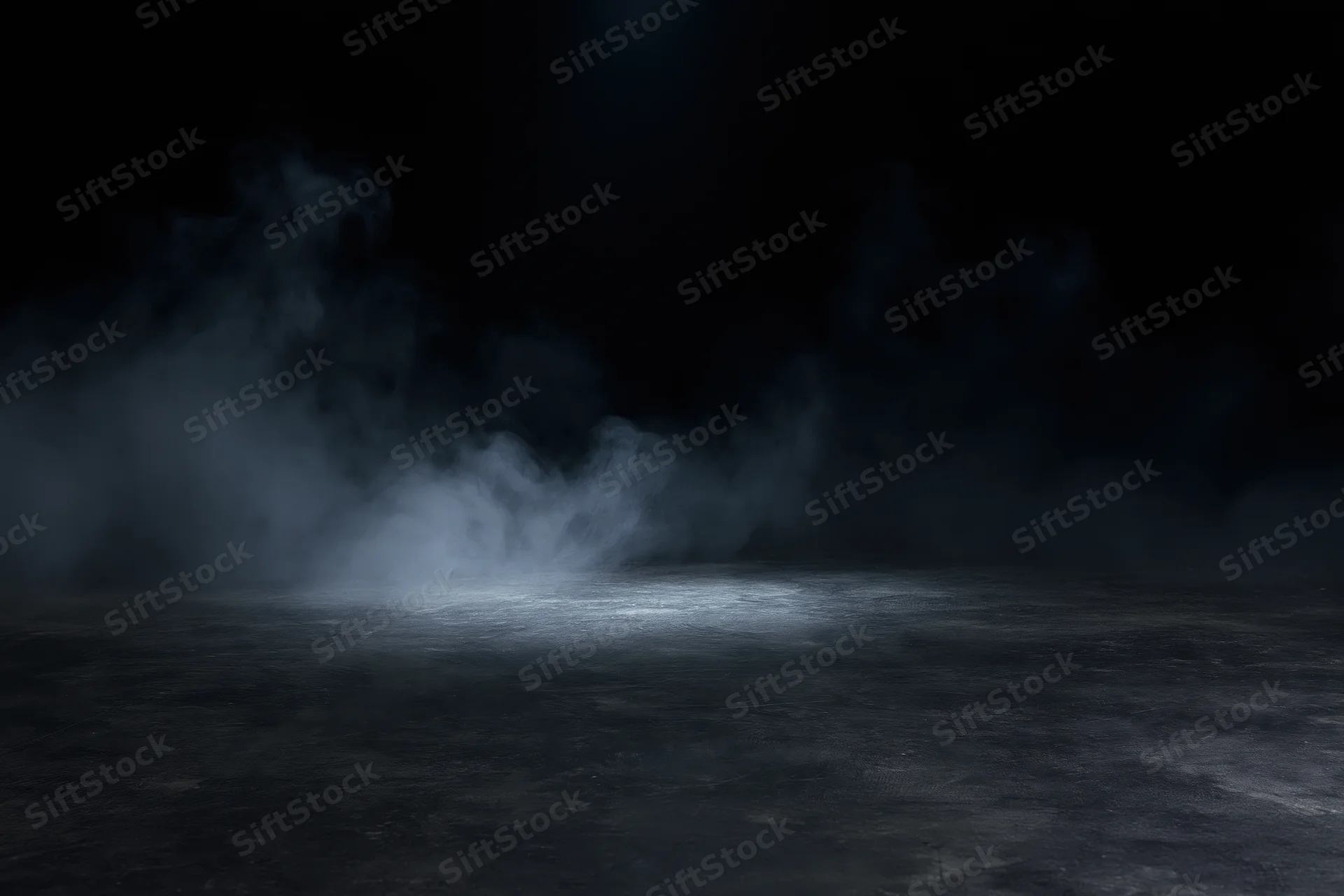Wisps of smoke rising over a dark concrete floor under a spotlight
